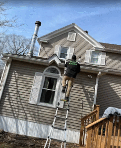 roofer climbing a ladder